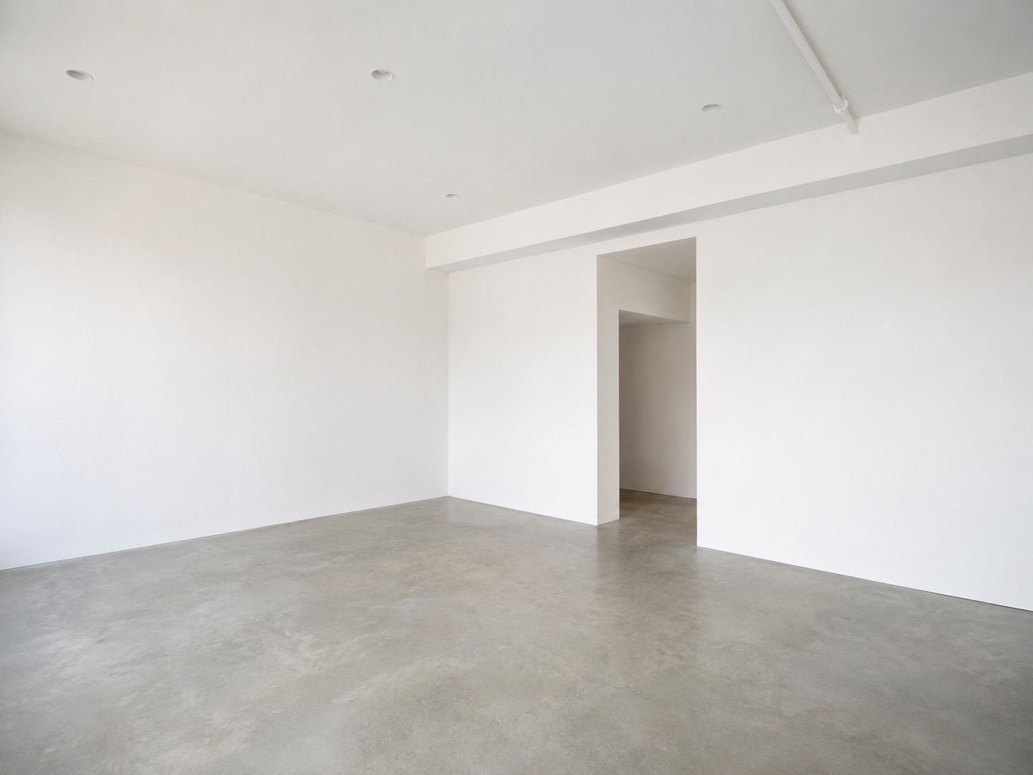 Empty full-floor loft with white walls and concrete floor at 52 Greene Street